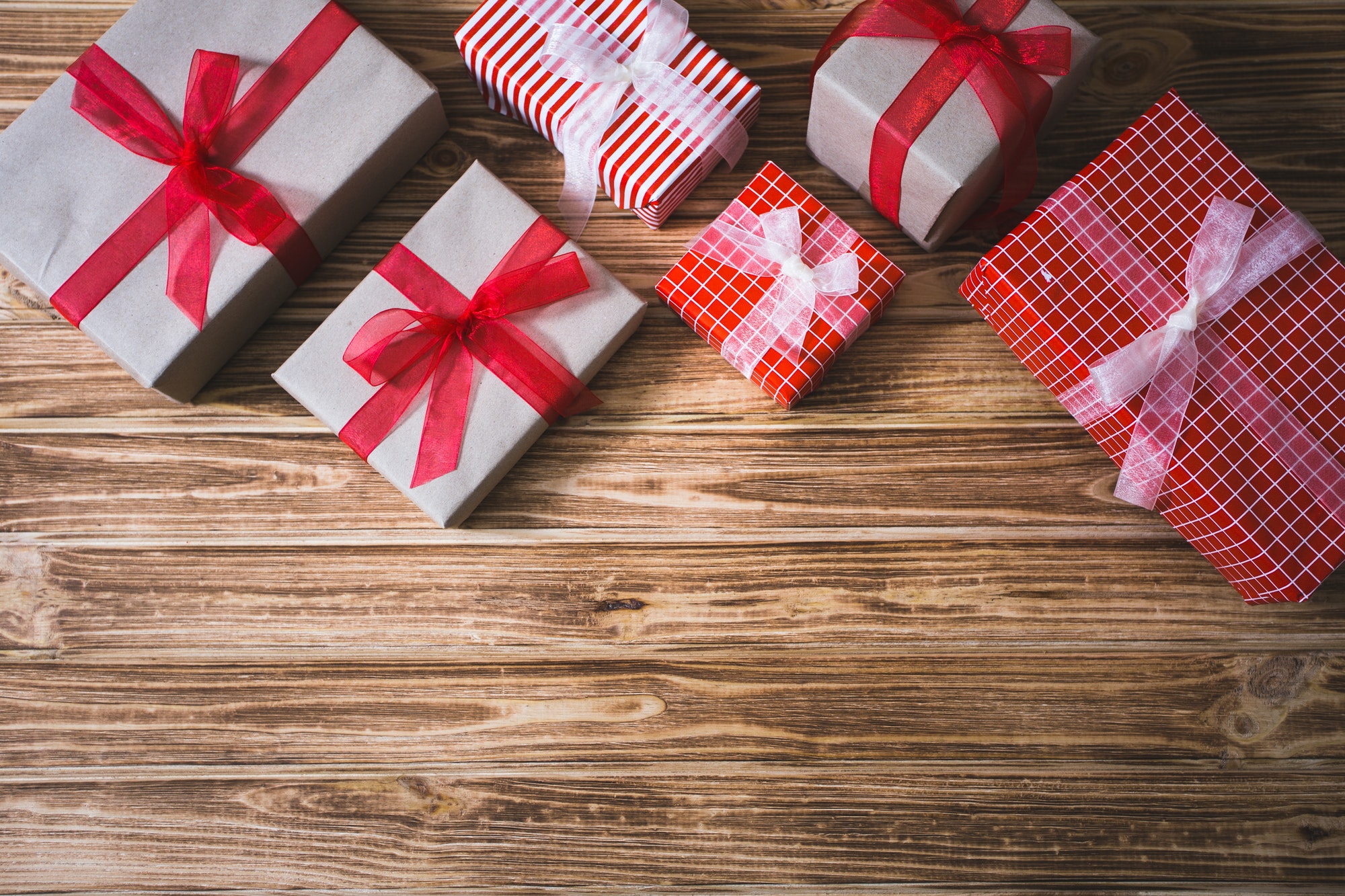 Christmas presents on a wooden background, candle.